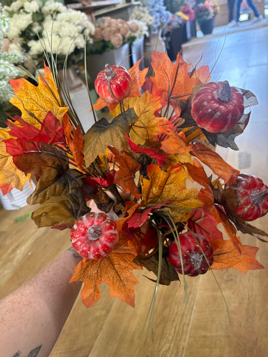 Large autumn leaves and orange pumpkins bunch
