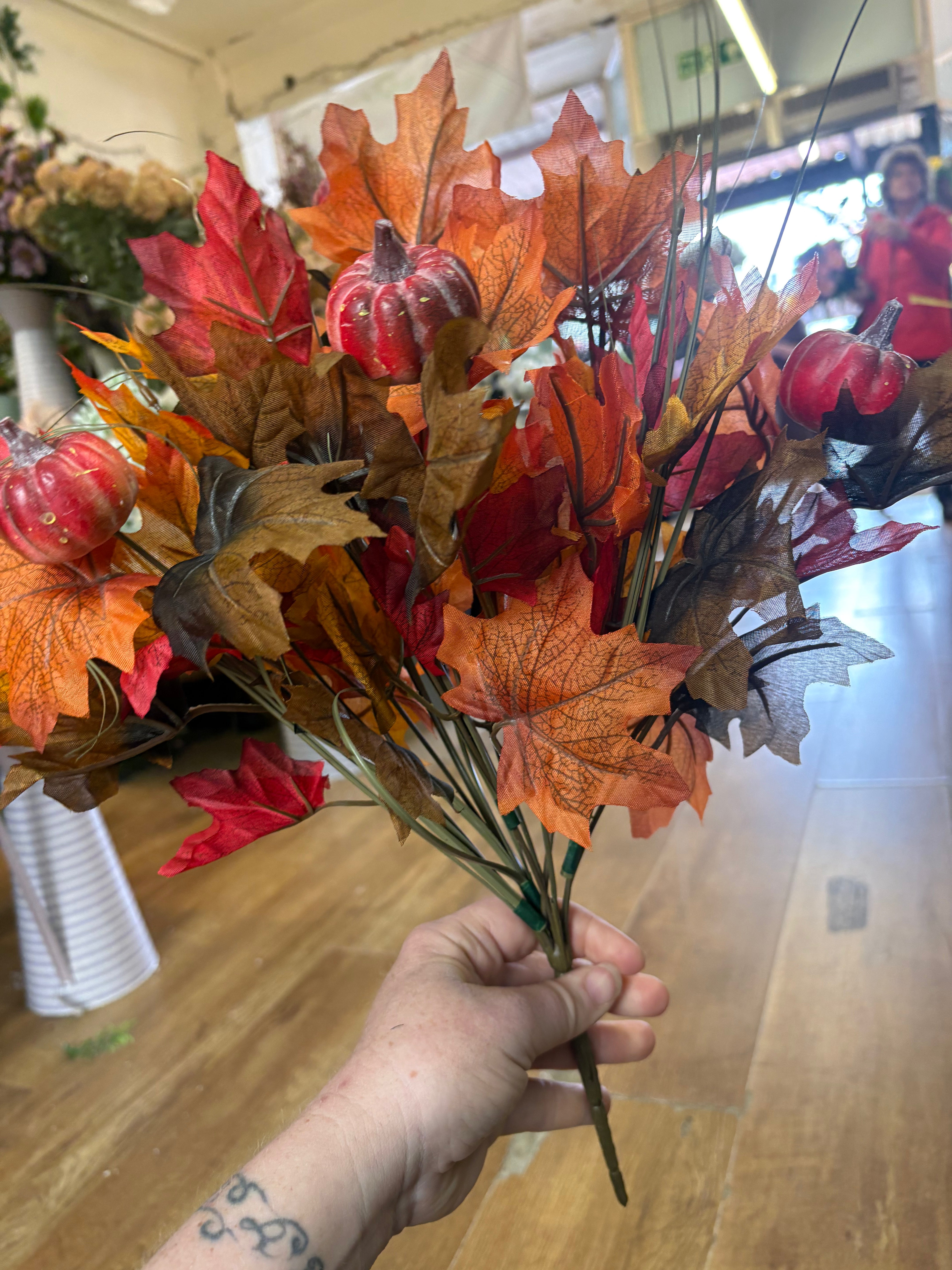 Large autumn leaves and orange pumpkins bunch