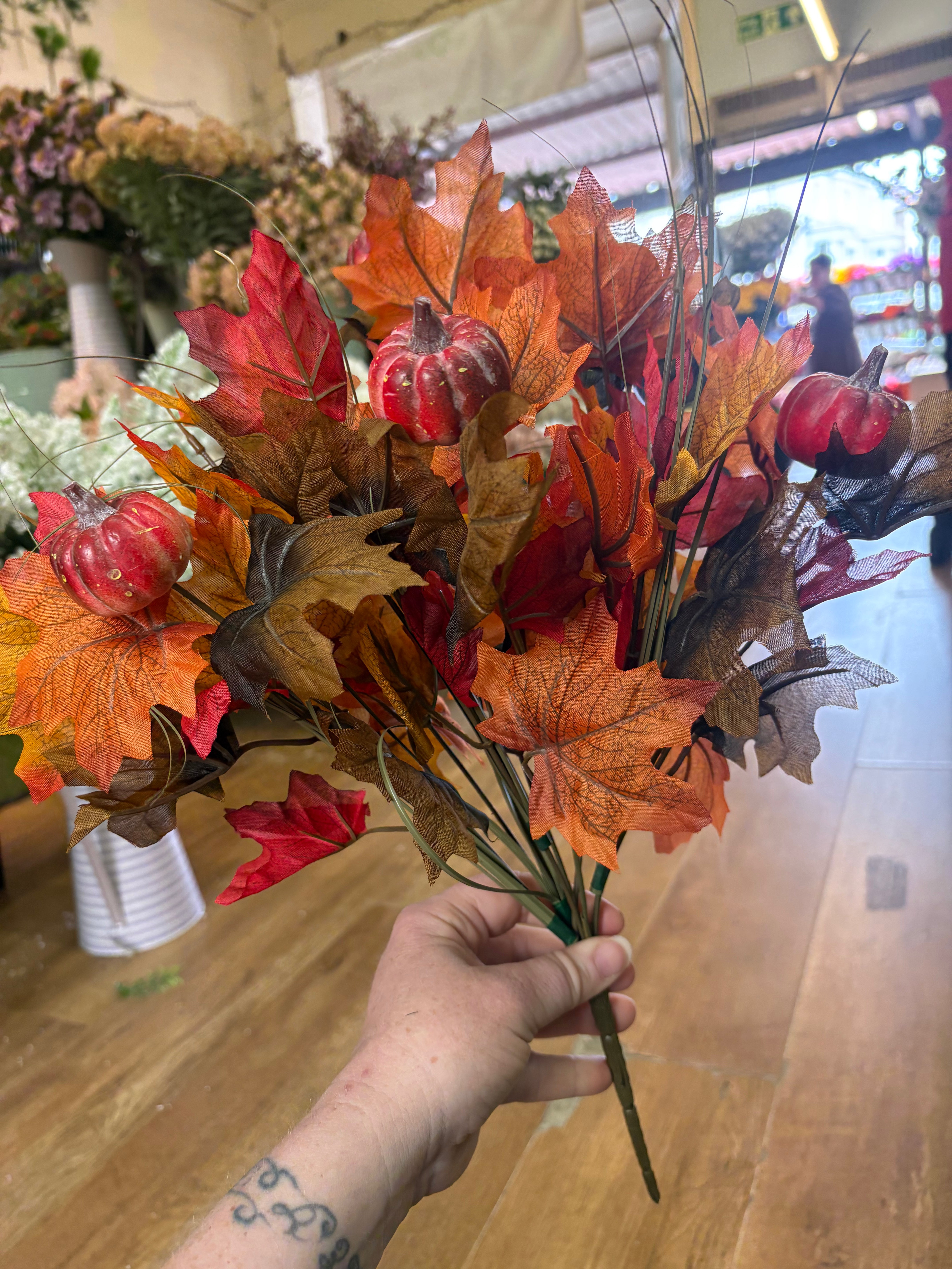Large autumn leaves and orange pumpkins bunch