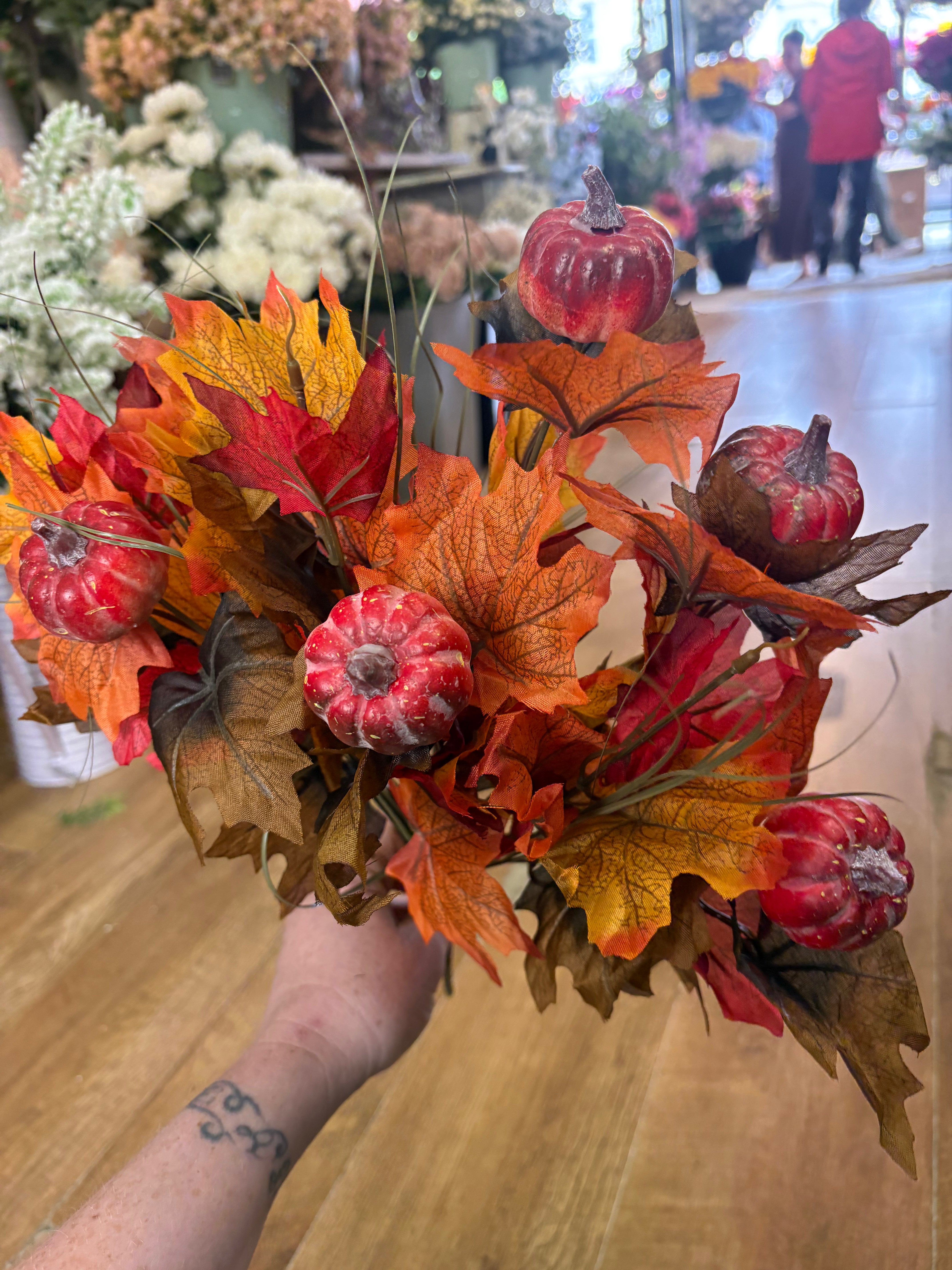 Large autumn leaves and orange pumpkins bunch