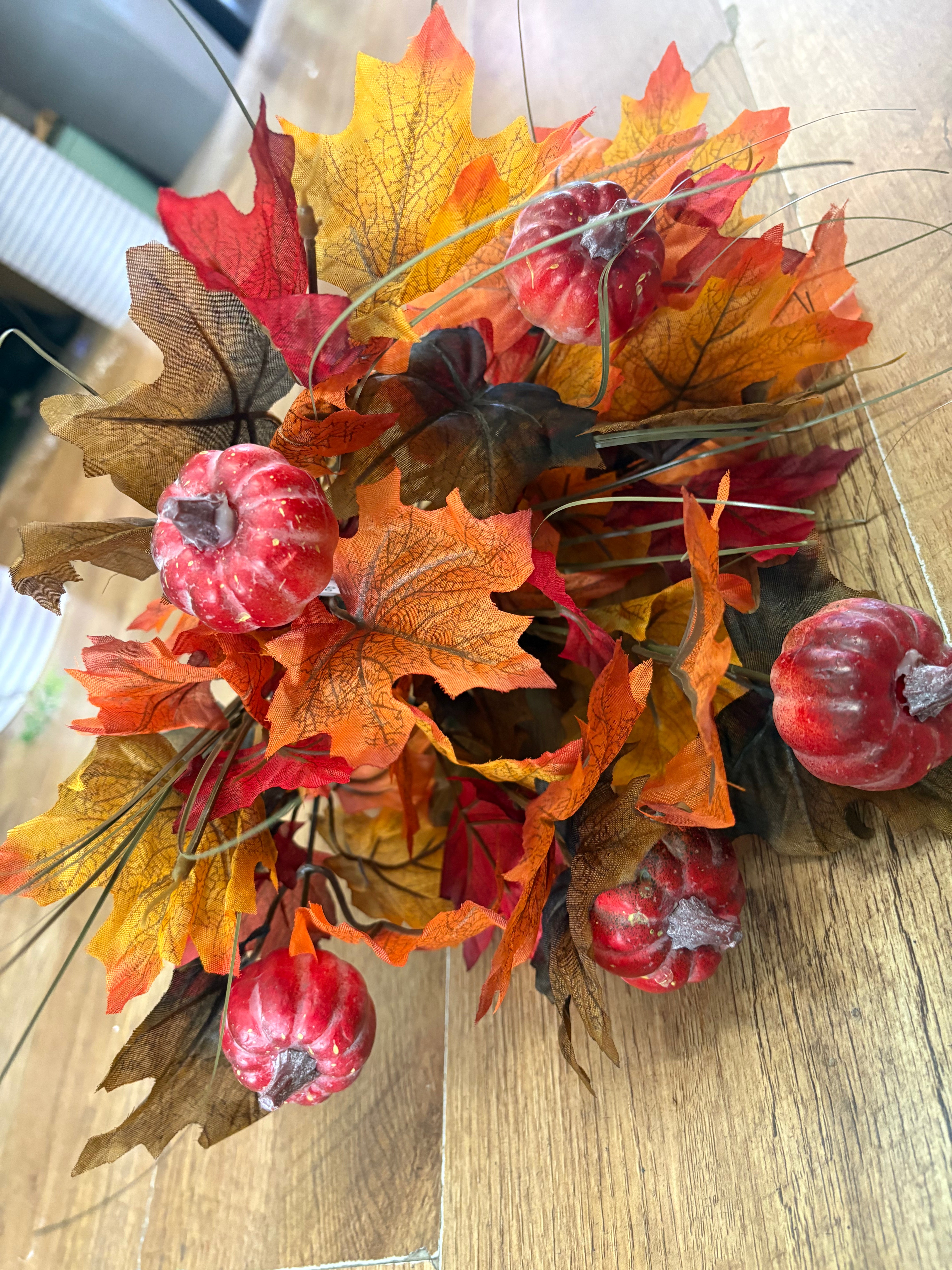 Large autumn leaves and orange pumpkins bunch