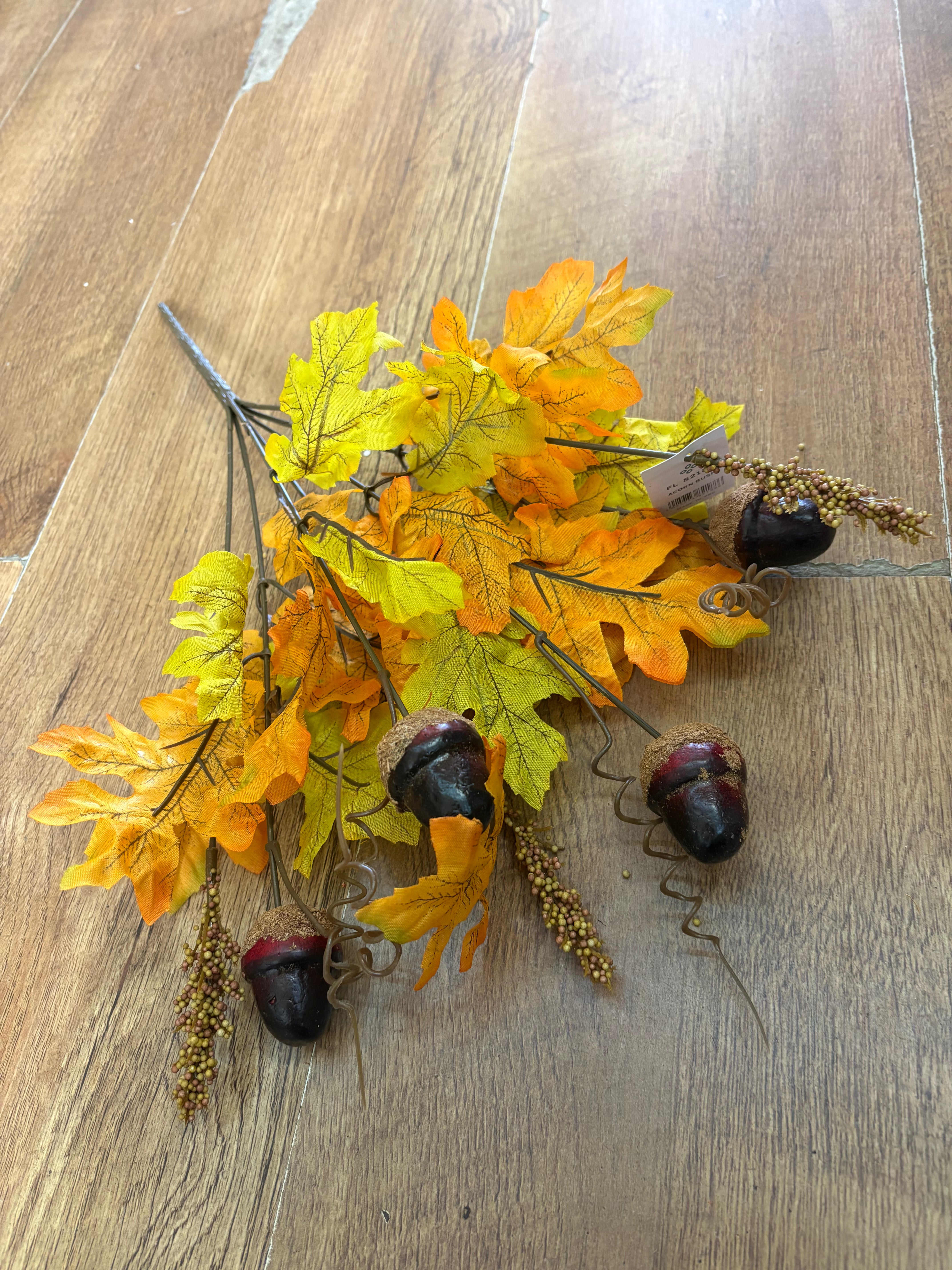 Pale orange and autumnal yellow acorn and foliage bunch