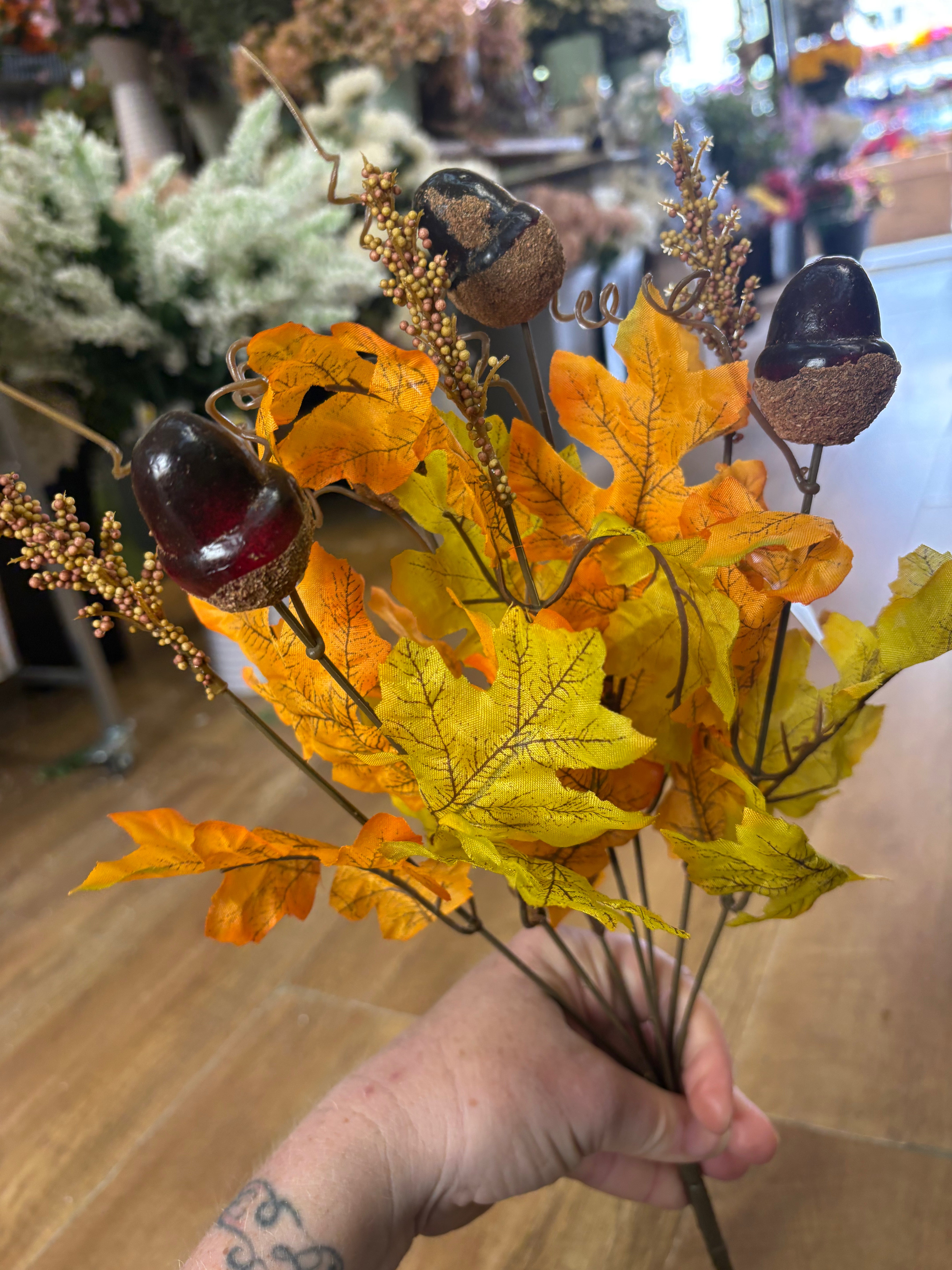 Pale orange and autumnal yellow acorn and foliage bunch