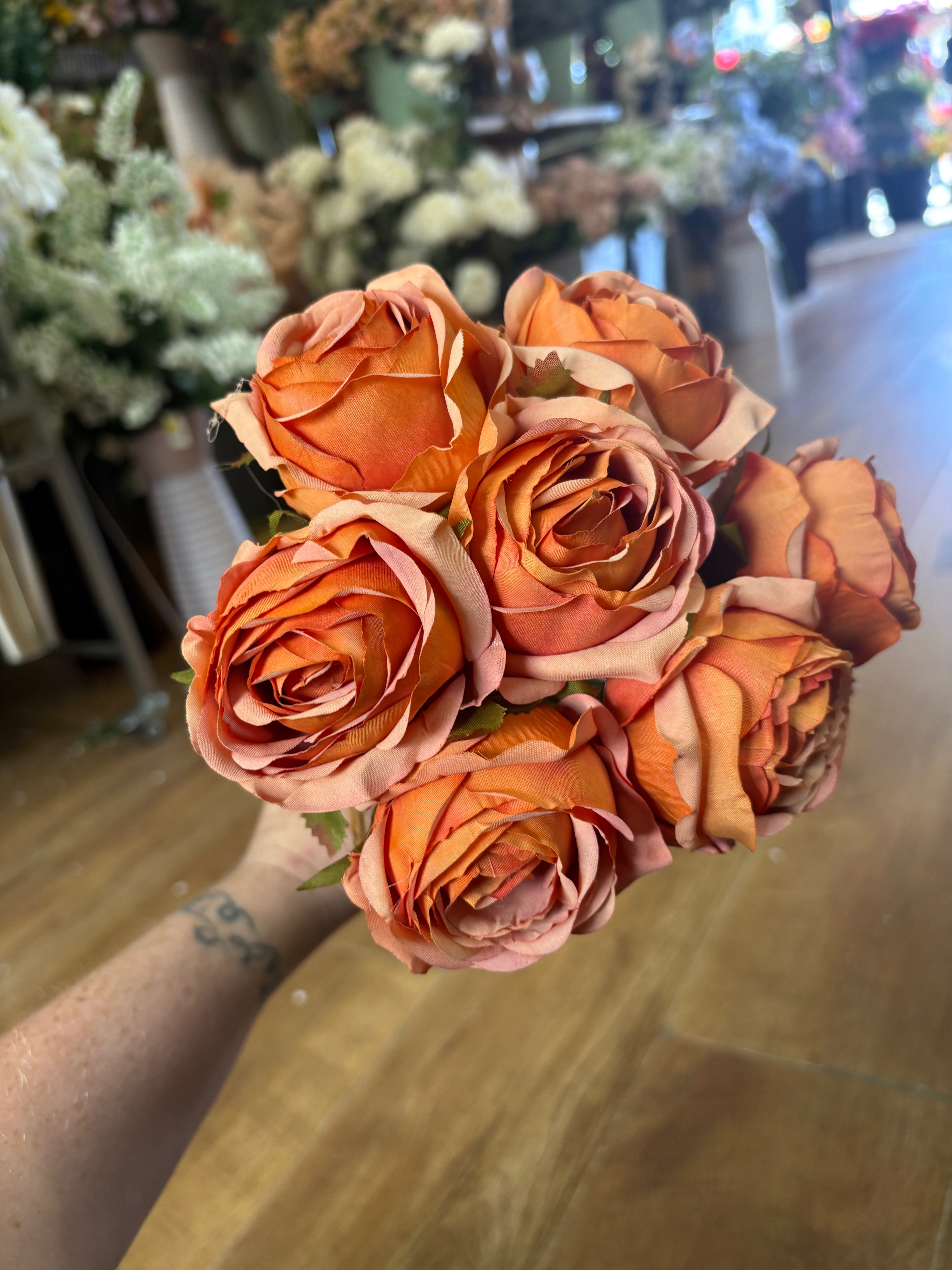 Hand tied bundle of 7 orange roses