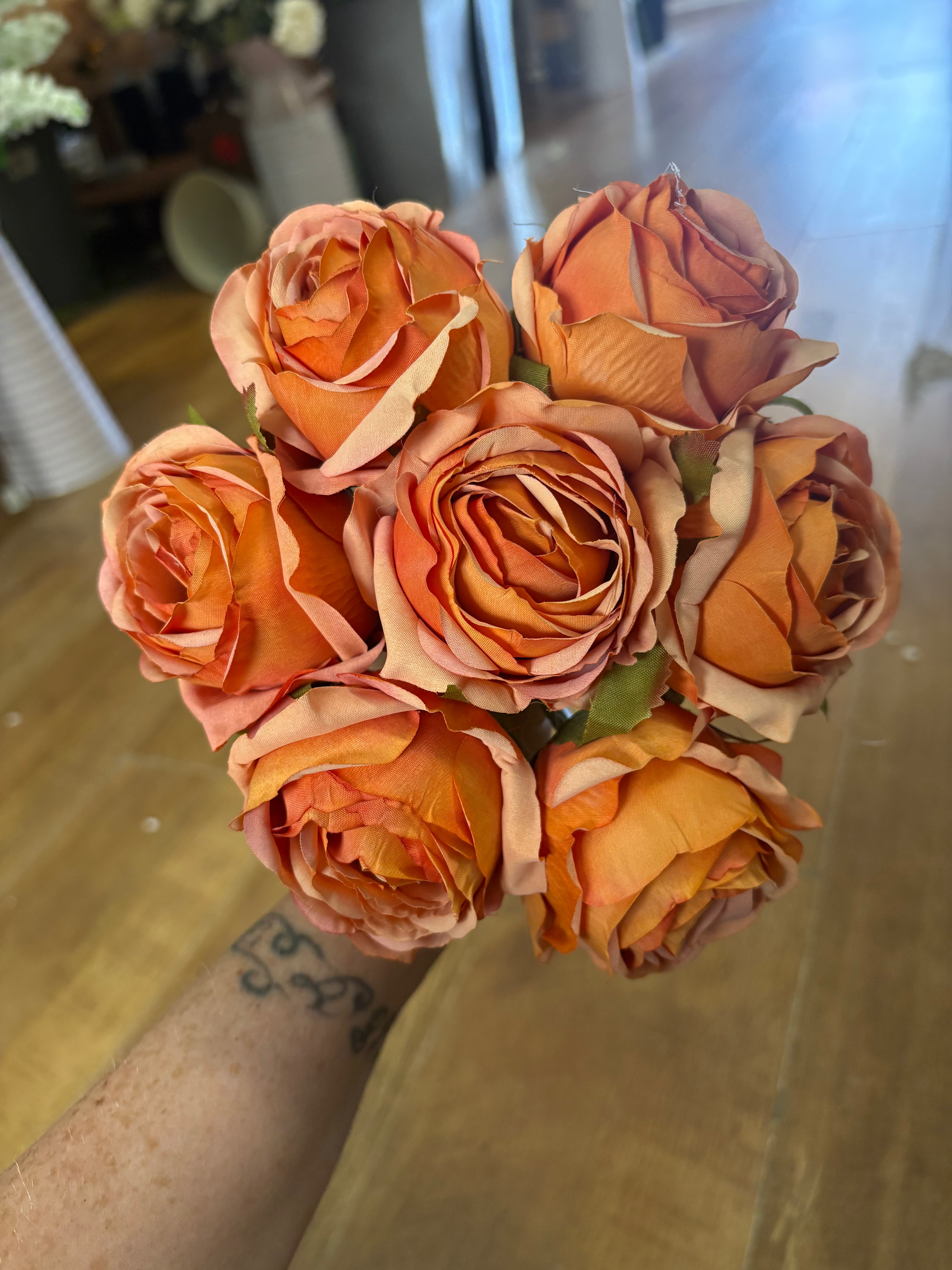 Hand tied bundle of 7 orange roses
