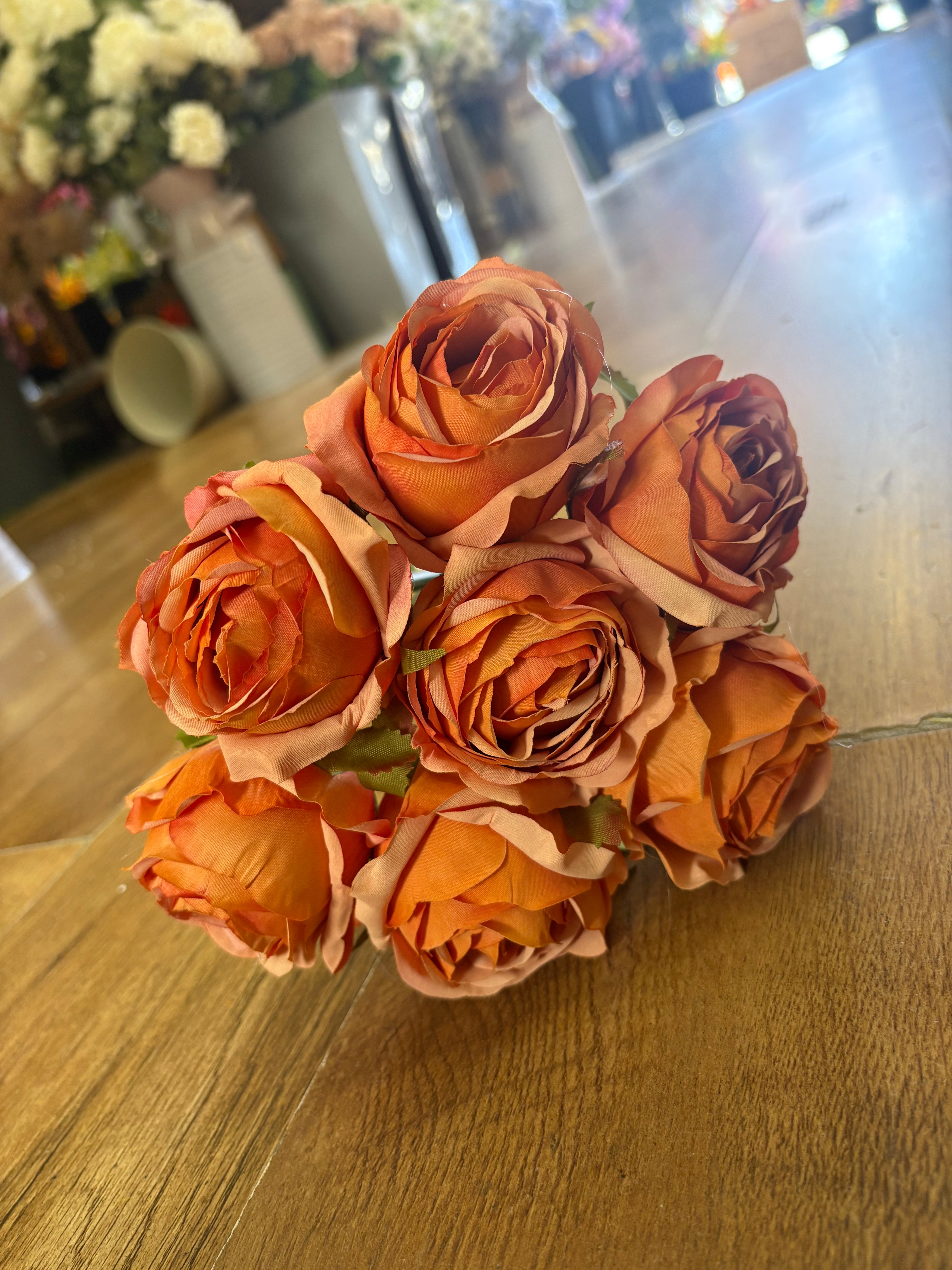 Hand tied bundle of 7 orange roses