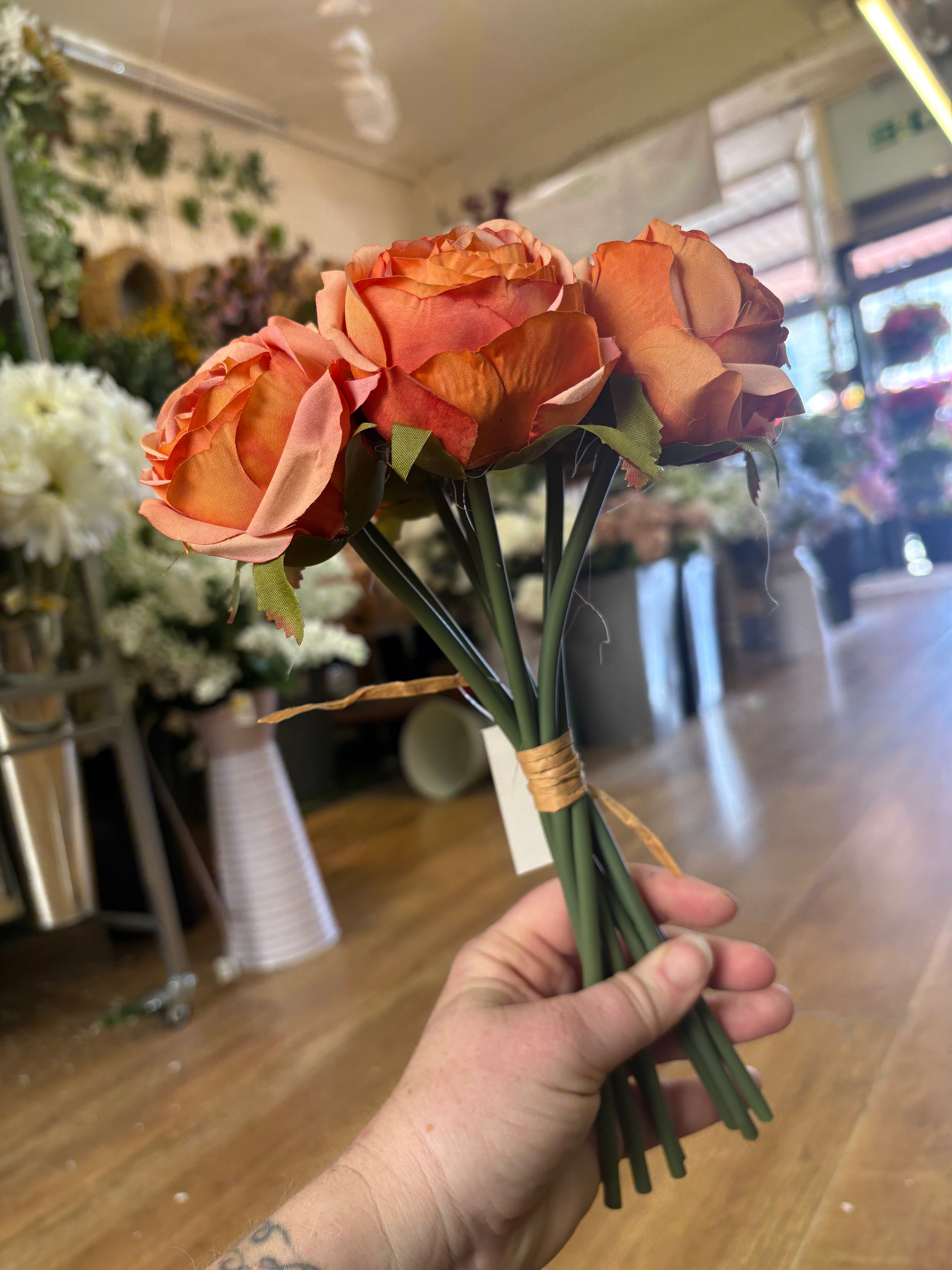 Hand tied bundle of 7 orange roses