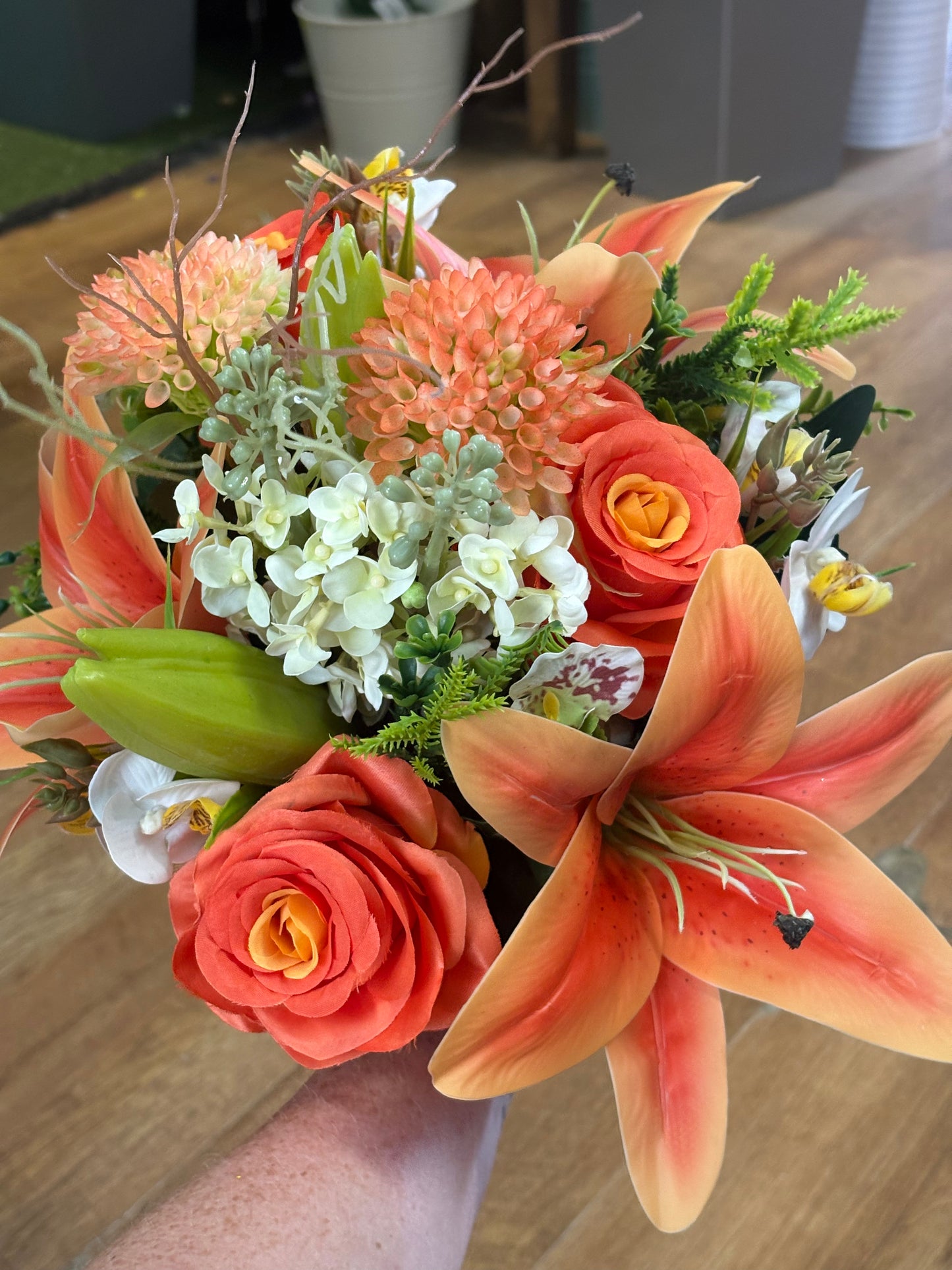 Orange Premium lily, rose and mixed florals/foliage bouquet with 1m of matching satin ribbon