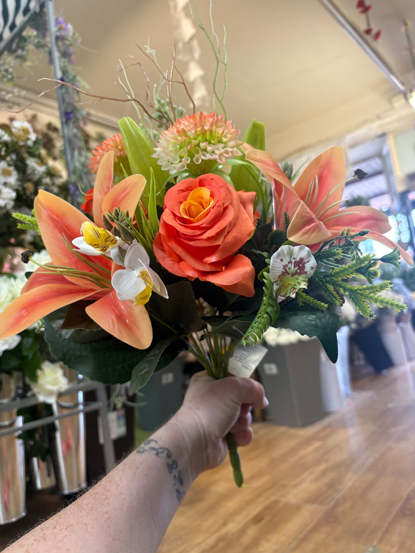 Orange Premium lily, rose and mixed florals/foliage bouquet with 1m of matching satin ribbon