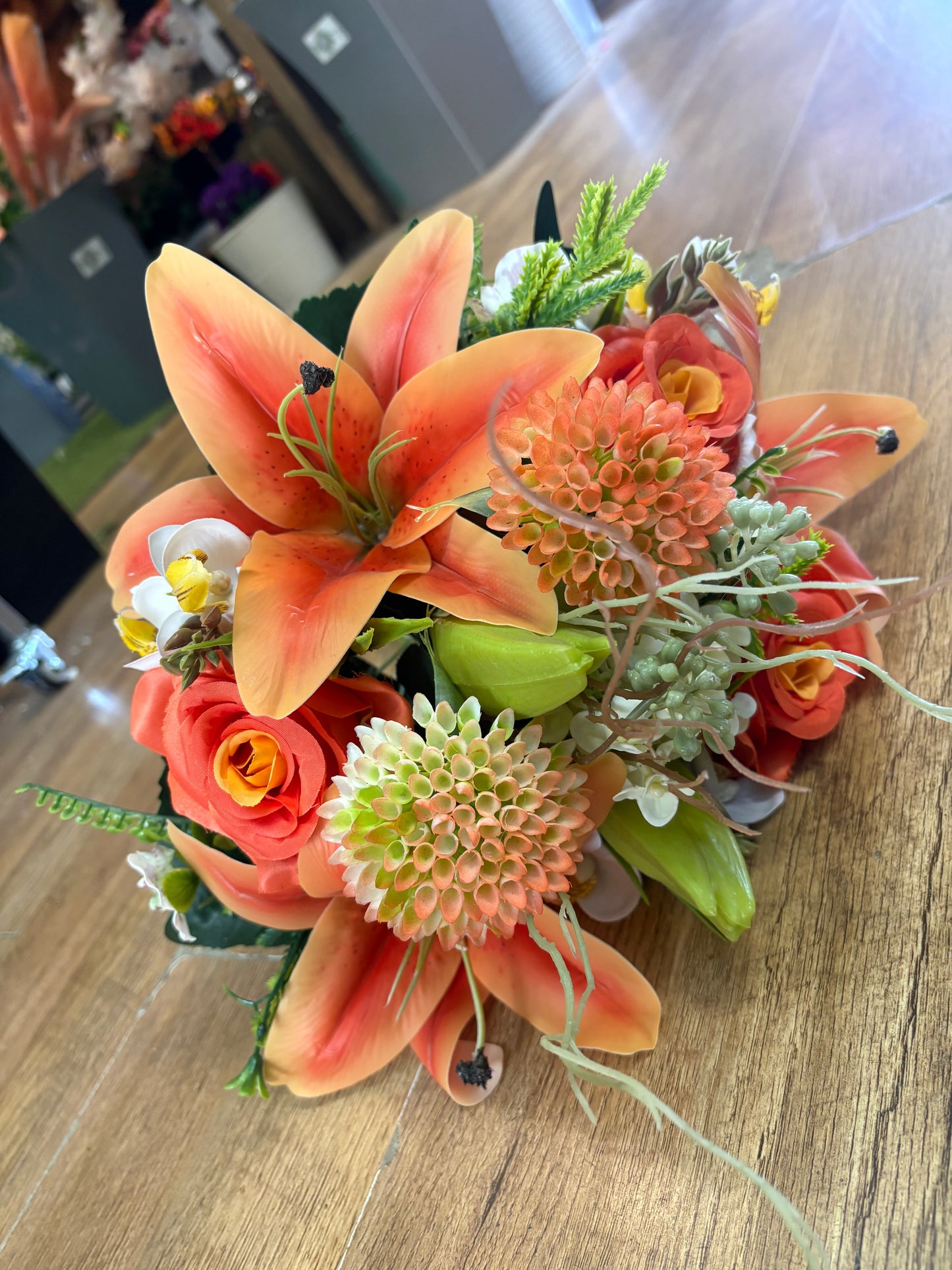 Orange Premium lily, rose and mixed florals/foliage bouquet with 1m of matching satin ribbon