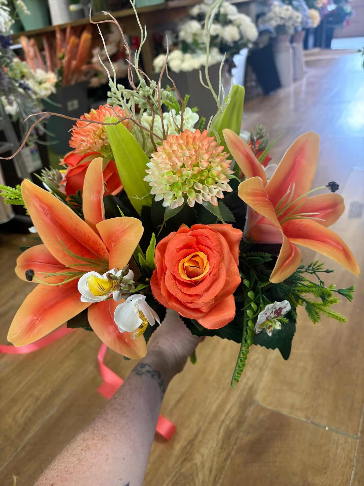 Orange Premium lily, rose and mixed florals/foliage bouquet with 1m of matching satin ribbon