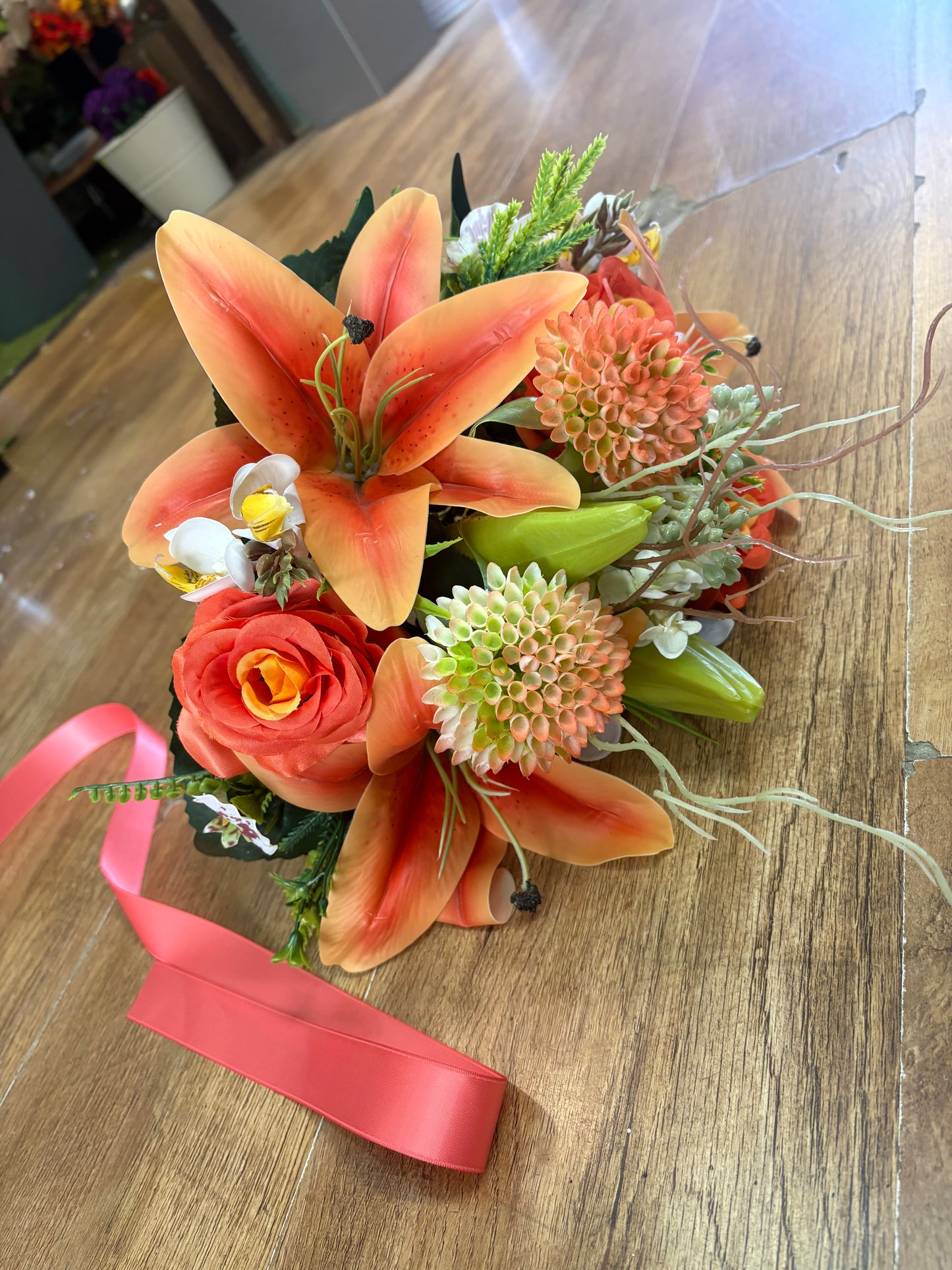 Orange Premium lily, rose and mixed florals/foliage bouquet with 1m of matching satin ribbon