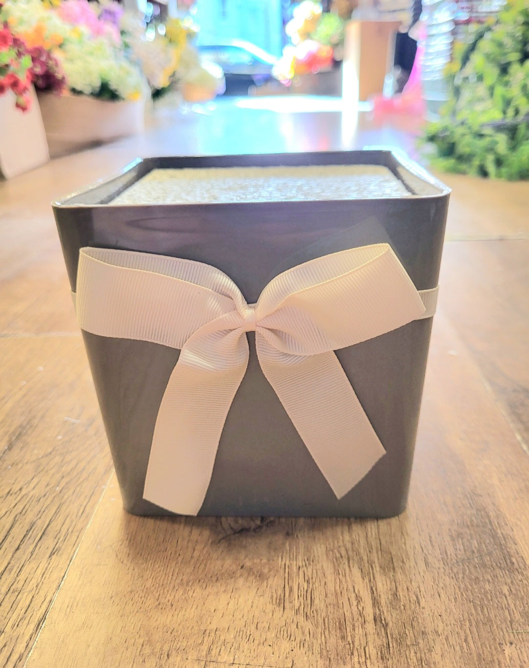 Grey floral box with white bow and filled with polystyrene  image 0