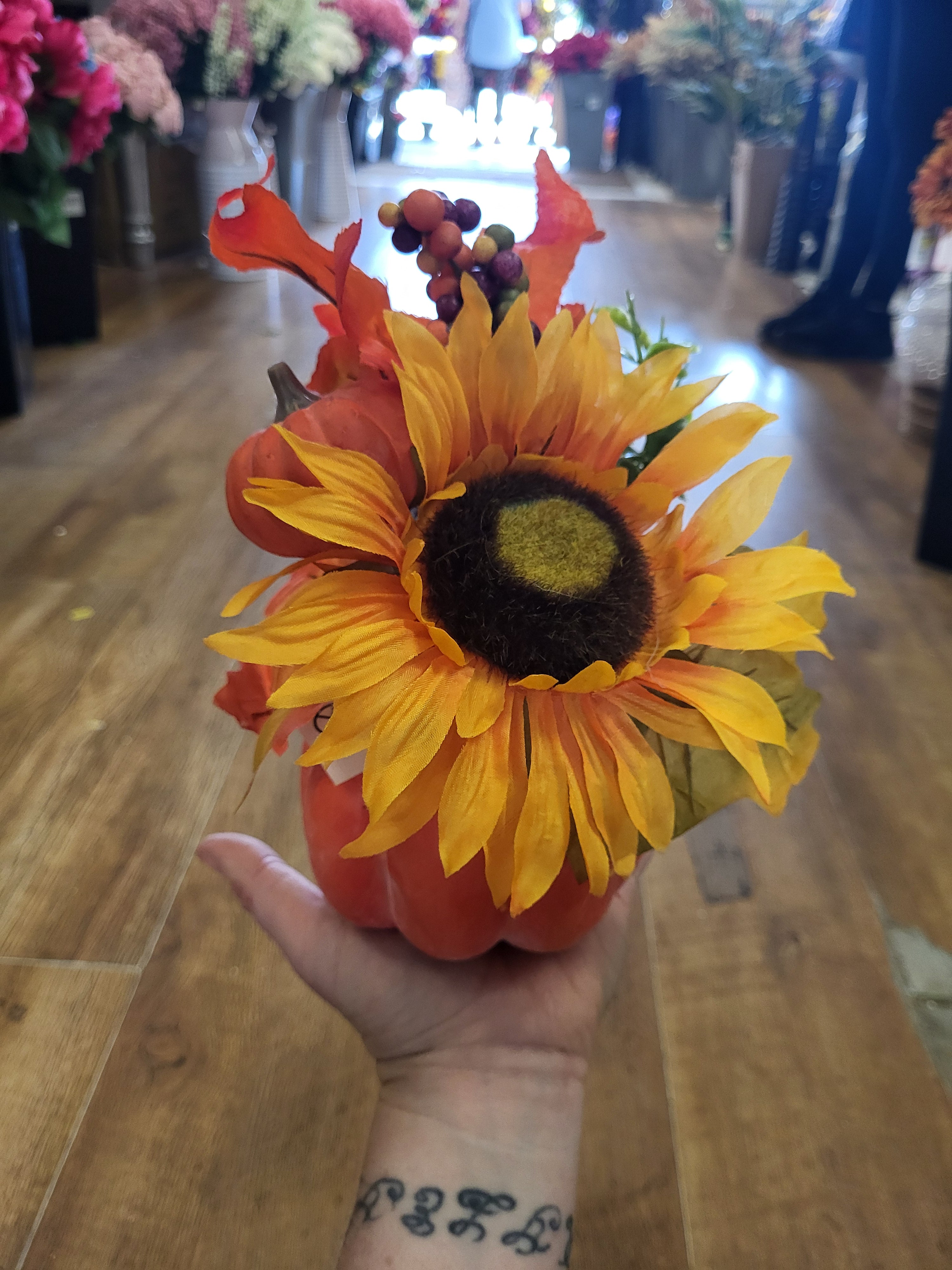 Sunflower/berry/foliage in pumpkin display  image 0