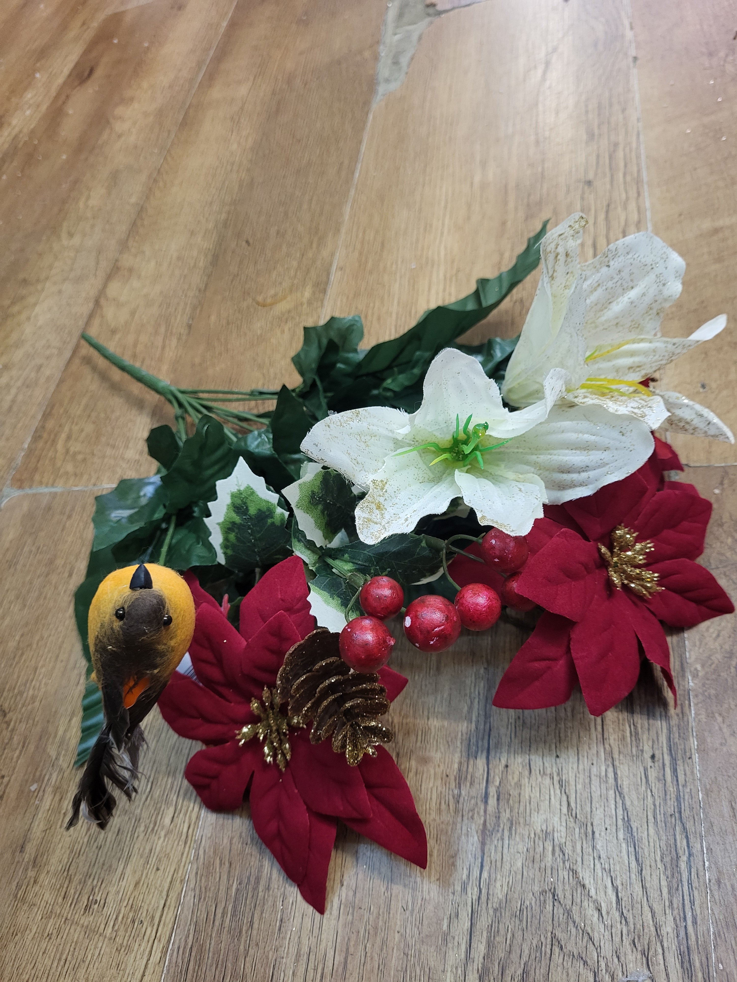 Poinsettia, lily and robin bouquet  image 0