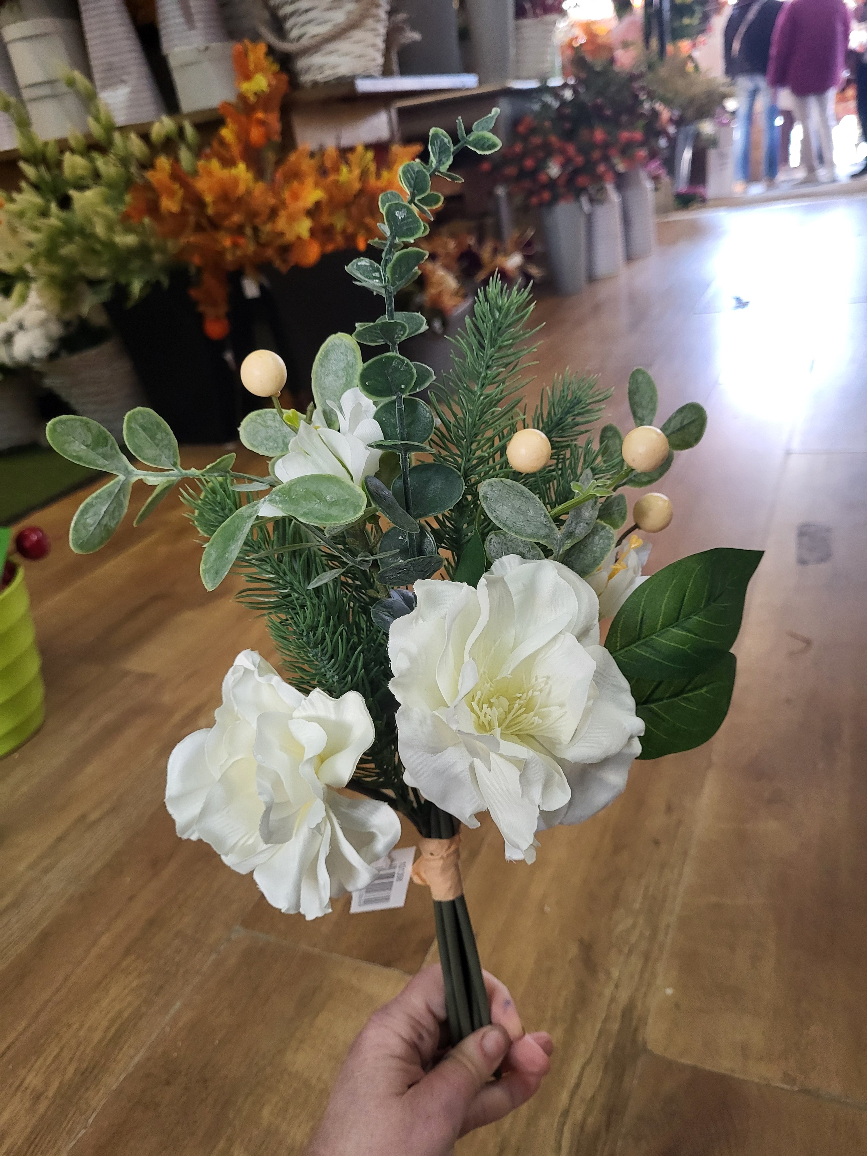 Hand tied winter foliage bundle with ivory flowers and cream berries image 1
