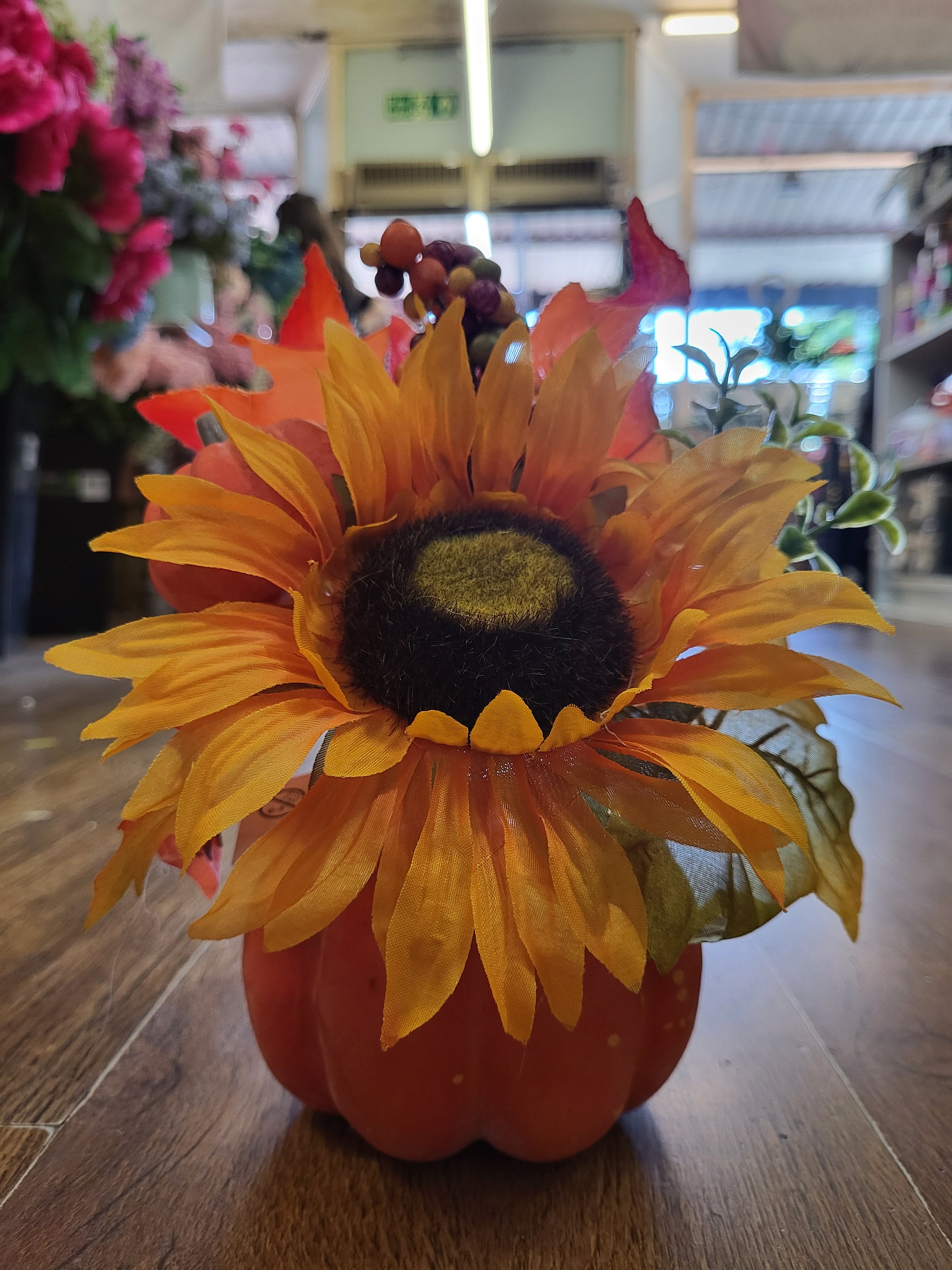 Sunflower/berry/foliage in pumpkin display  image 9
